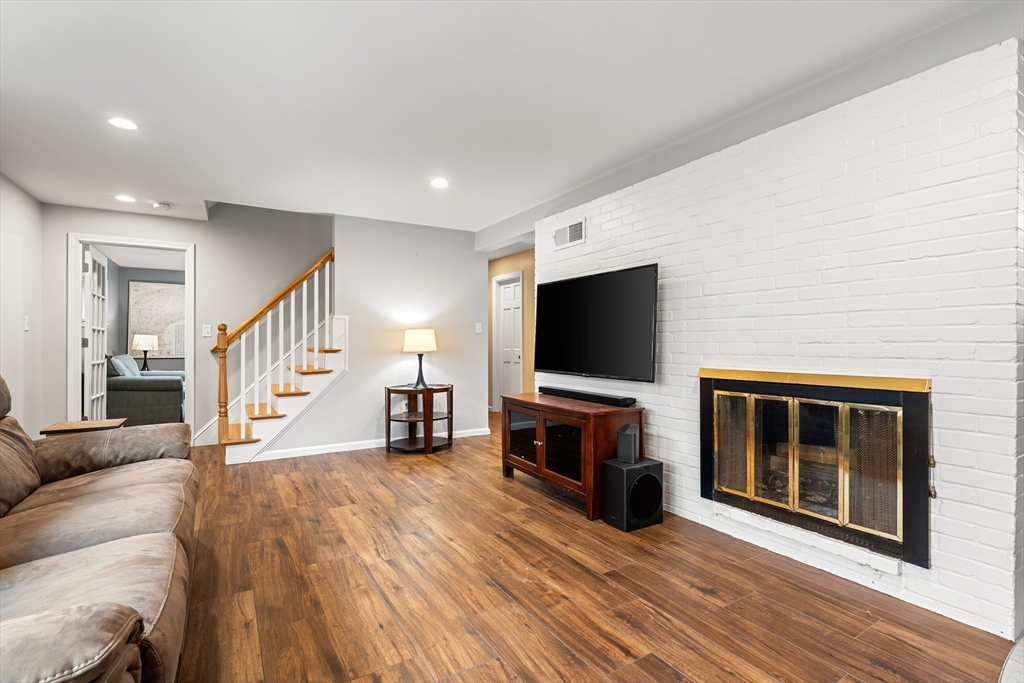 51 Winslow Road Reading, MA 01867 - Photo 6 of 40 a living room with furniture and a flat screen tv