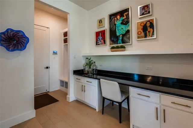 a large kitchen with stainless steel appliances granite countertop a sink a stove and a wooden floors