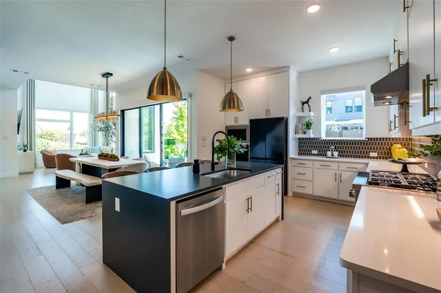 a kitchen with stainless steel appliances granite countertop a stove refrigerator a oven a sink and a microwave