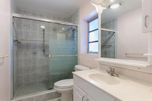 a bathroom with a sink toilet and shower
