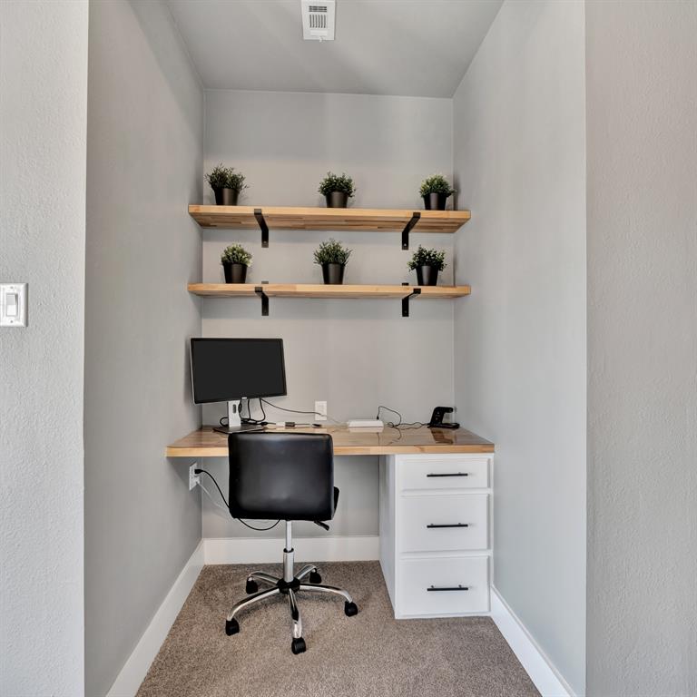 602 Winners Circle Rowlett, TX 75088 - Photo 24 of 35 Dedicated workspace featuring a built-in wood-finish desk and white drawer unit