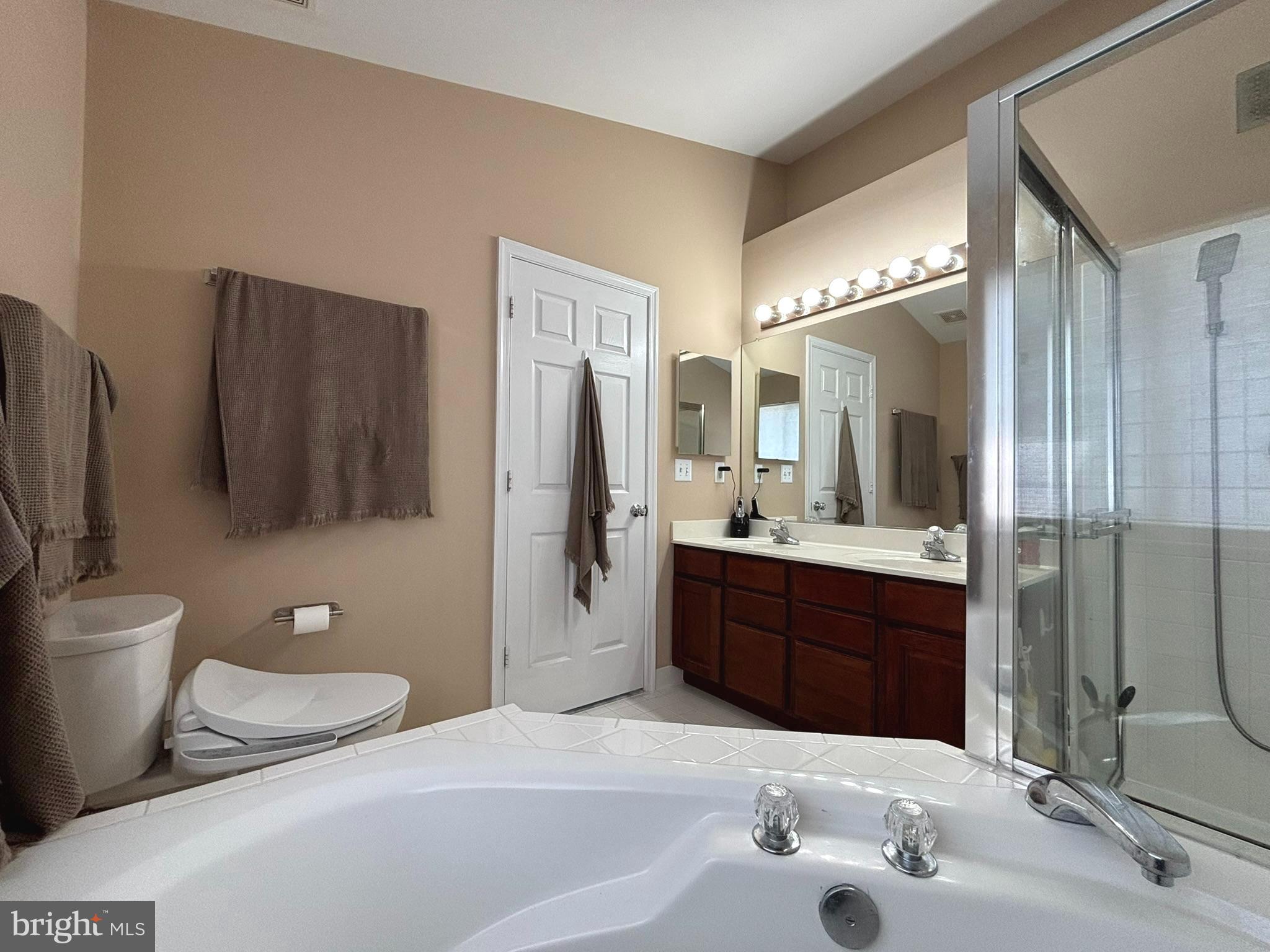 6659 Patent Parish Lane Alexandria, VA 22315 - Photo 11 of 16 a bathroom with a granite countertop sink toilet and shower