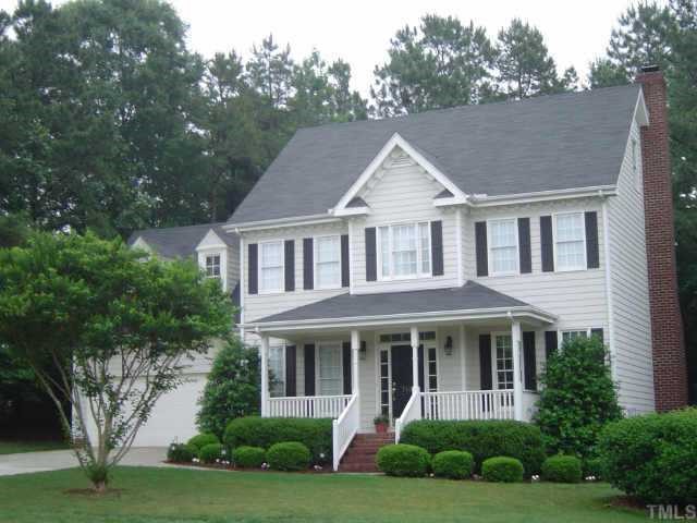 7104 Wilderness Road Raleigh, NC 27613 - Photo 1 of 1 a view of a white house with a yard plants and large tree
