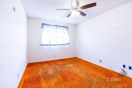 1224 North Inyo Street Ridgecrest, CA 93555 - Photo 15 of 28 a view of a big room with windows and chandelier fan