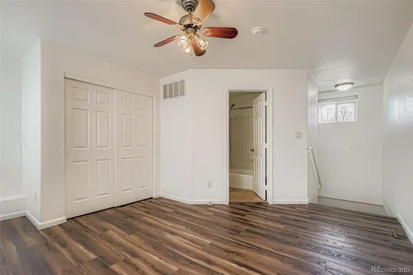 a view of empty room with wooden floor