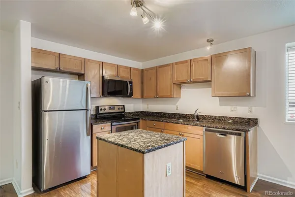 a kitchen with a refrigerator stove and microwave