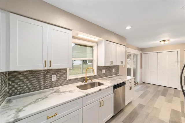 a kitchen with a sink stove and cabinets