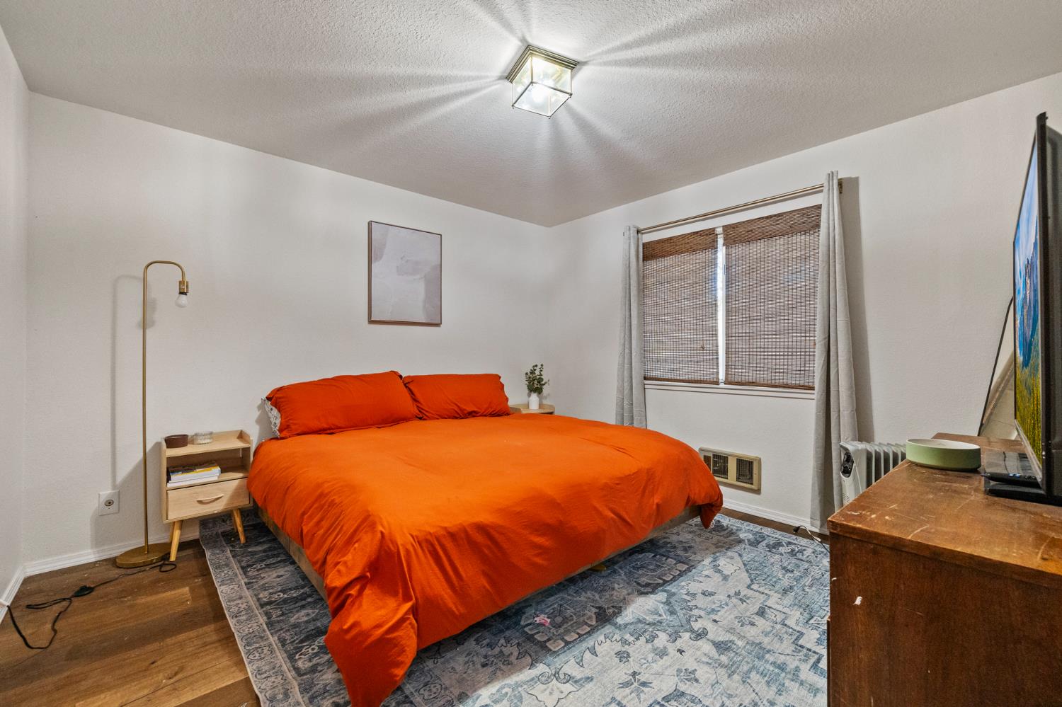 1480 Pennsylvania Gulch Road Murphys, CA 95247 - Photo 18 of 31 a bedroom with a bed and a flat tv screen on dresser