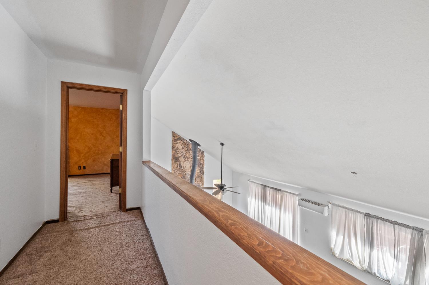1480 Pennsylvania Gulch Road Murphys, CA 95247 - Photo 19 of 31 a view of a hallway with wooden floor and a bathroom