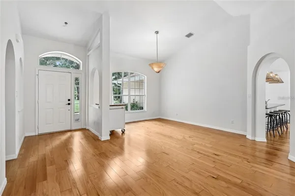 a view of livingroom with hardwood floor and a kitchen
