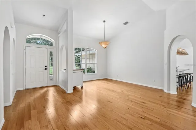 a view of livingroom with hardwood floor and a kitchen