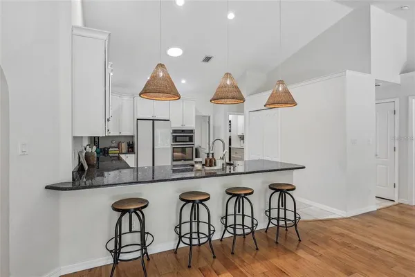 a kitchen with stainless steel appliances kitchen island a chandelier