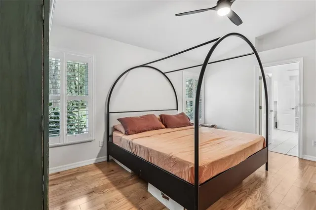 a bed sitting in a bedroom next to a window