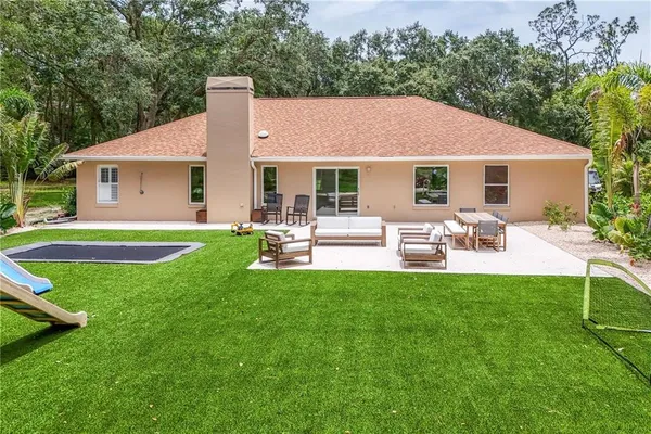 a front view of house with a garden and patio