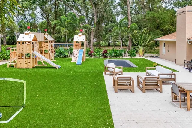 a view of a house with backyard porch and sitting area