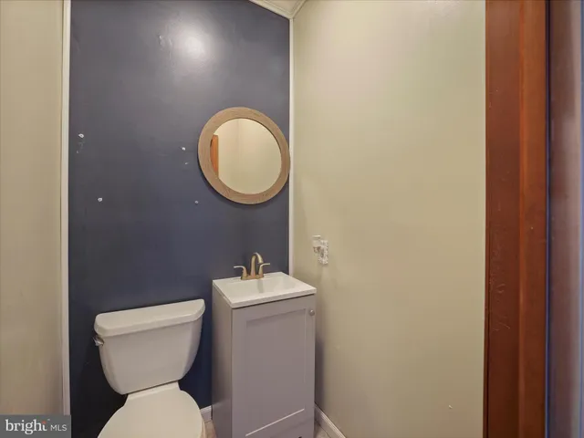 a large kitchen with granite countertop a stove a sink a refrigerator dining table and chairs