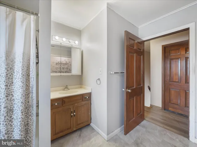 a bedroom with a bed and a ceiling fan