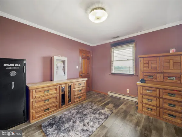 a spacious bedroom with a large bed a chandelier and closet