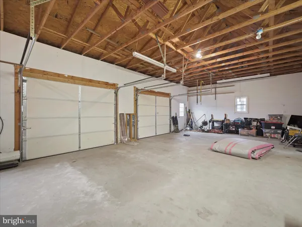 a utility room with dryer washer and a view of living room