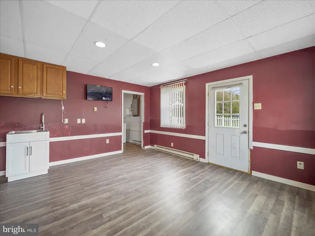 a utility room with dryer washer and a view of living room