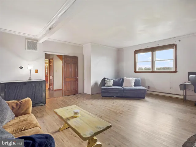 a view of a room with furniture and a window