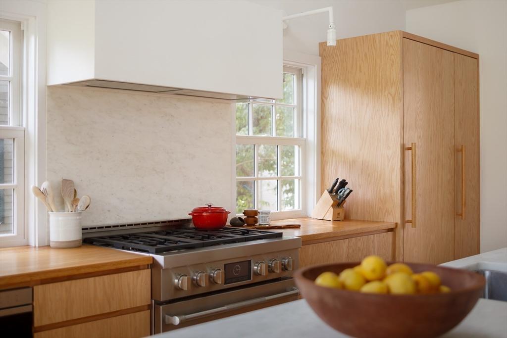 20 Brown Street Cambridge, MA 02138 - Photo 5 of 21 a kitchen with stainless steel appliances granite countertop a sink stove and refrigerator