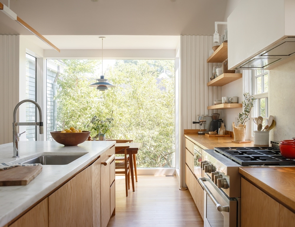 20 Brown Street Cambridge, MA 02138 - Photo 6 of 21 a kitchen with a stove a sink and a wooden cabinets