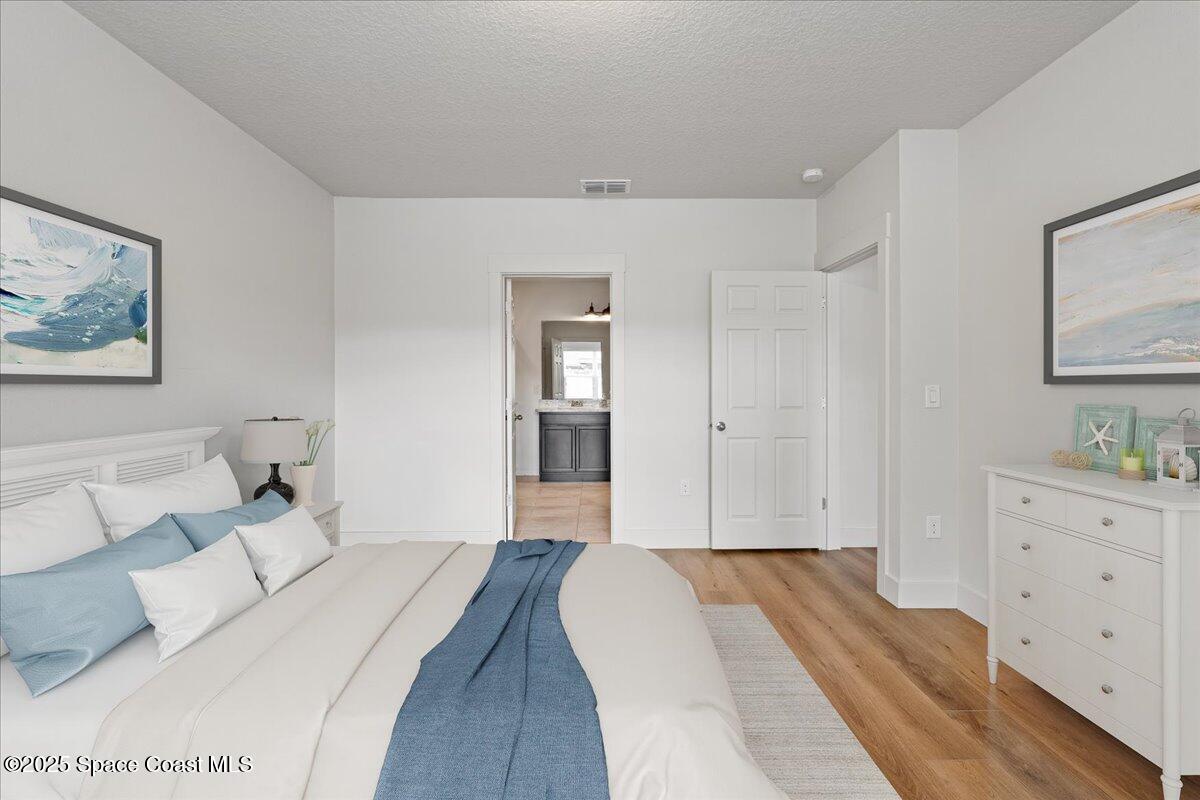 1120 Swiss Pointe Lane Rockledge, FL 32955 - Photo 14 of 47 a bedroom with a bed and a couch