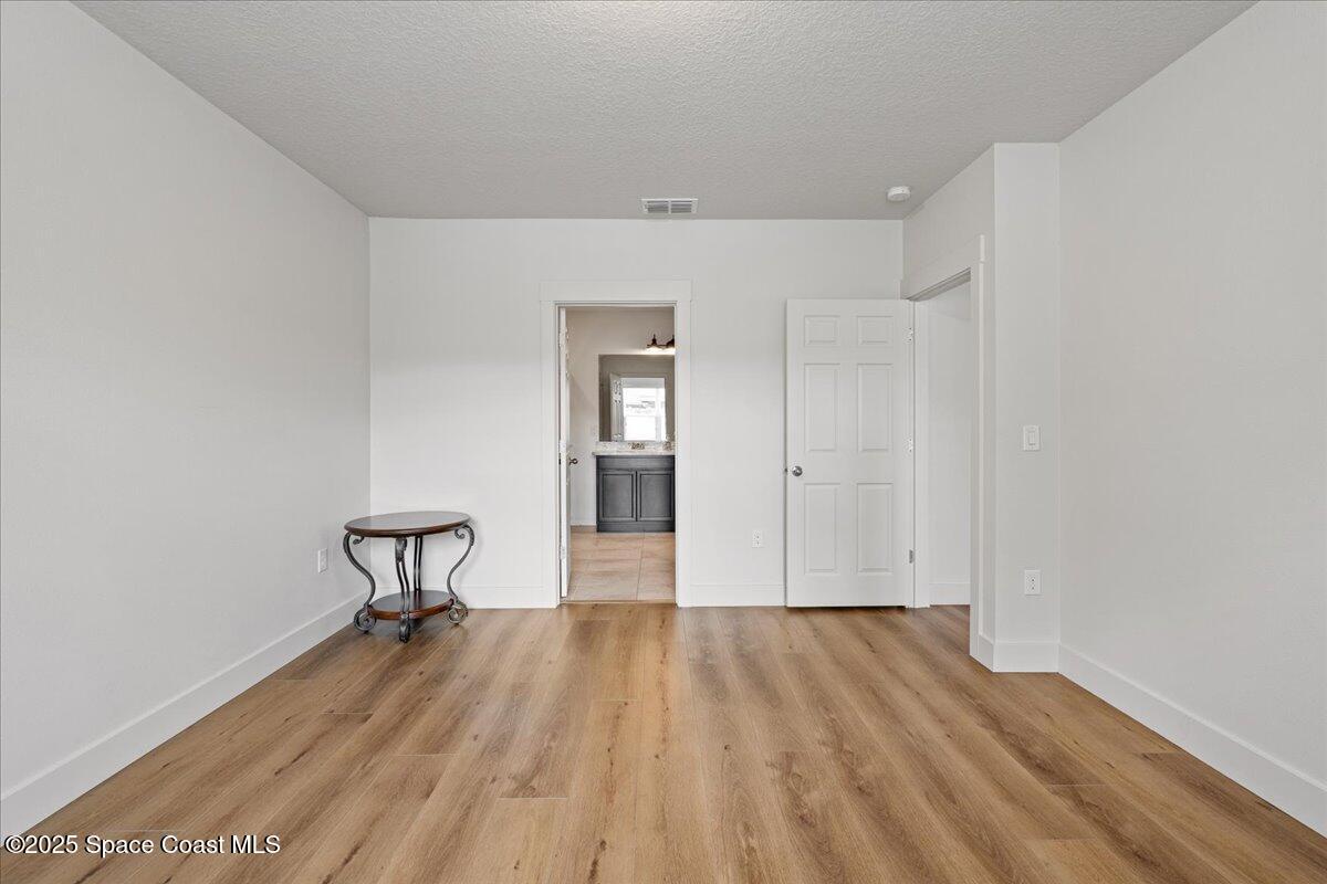 1120 Swiss Pointe Lane Rockledge, FL 32955 - Photo 15 of 47 a view of a room with wooden floor and a bench