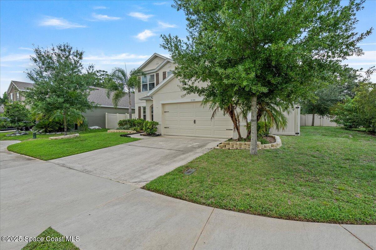 1120 Swiss Pointe Lane Rockledge, FL 32955 - Photo 2 of 47 a front view of a house with a yard