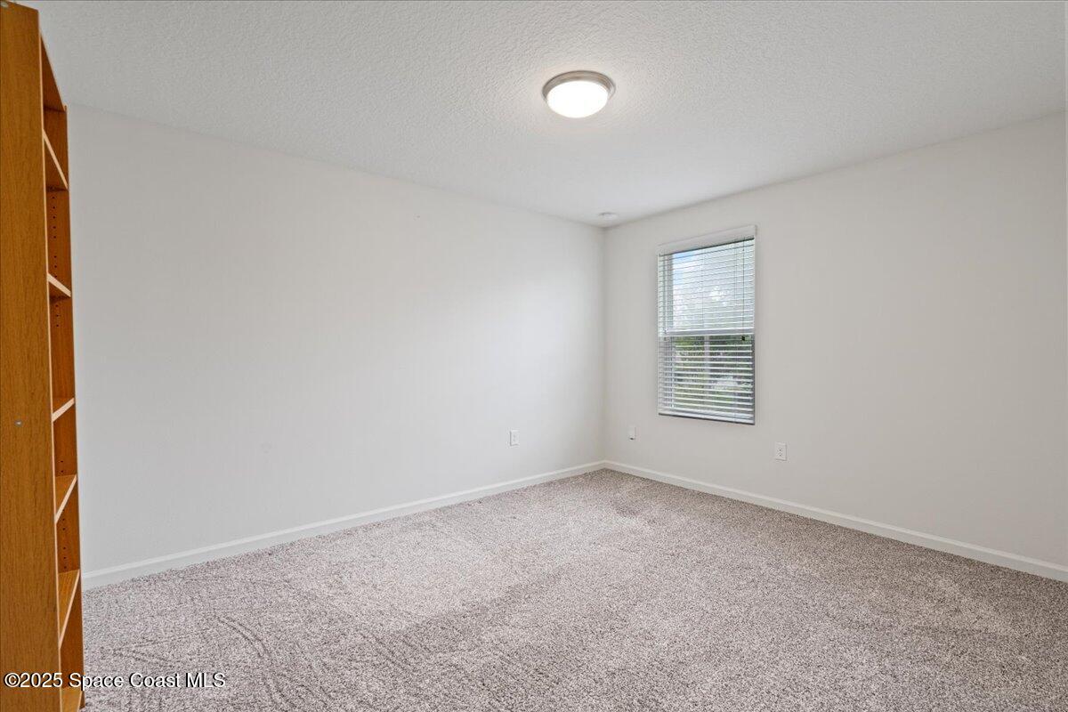 1120 Swiss Pointe Lane Rockledge, FL 32955 - Photo 23 of 47 an empty room with windows