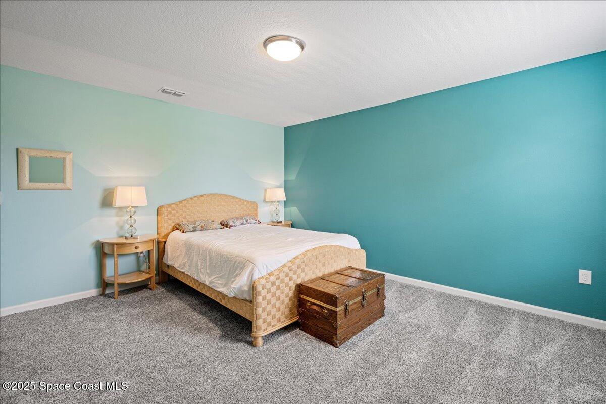 1120 Swiss Pointe Lane Rockledge, FL 32955 - Photo 27 of 47 a bedroom with a bed and lamp