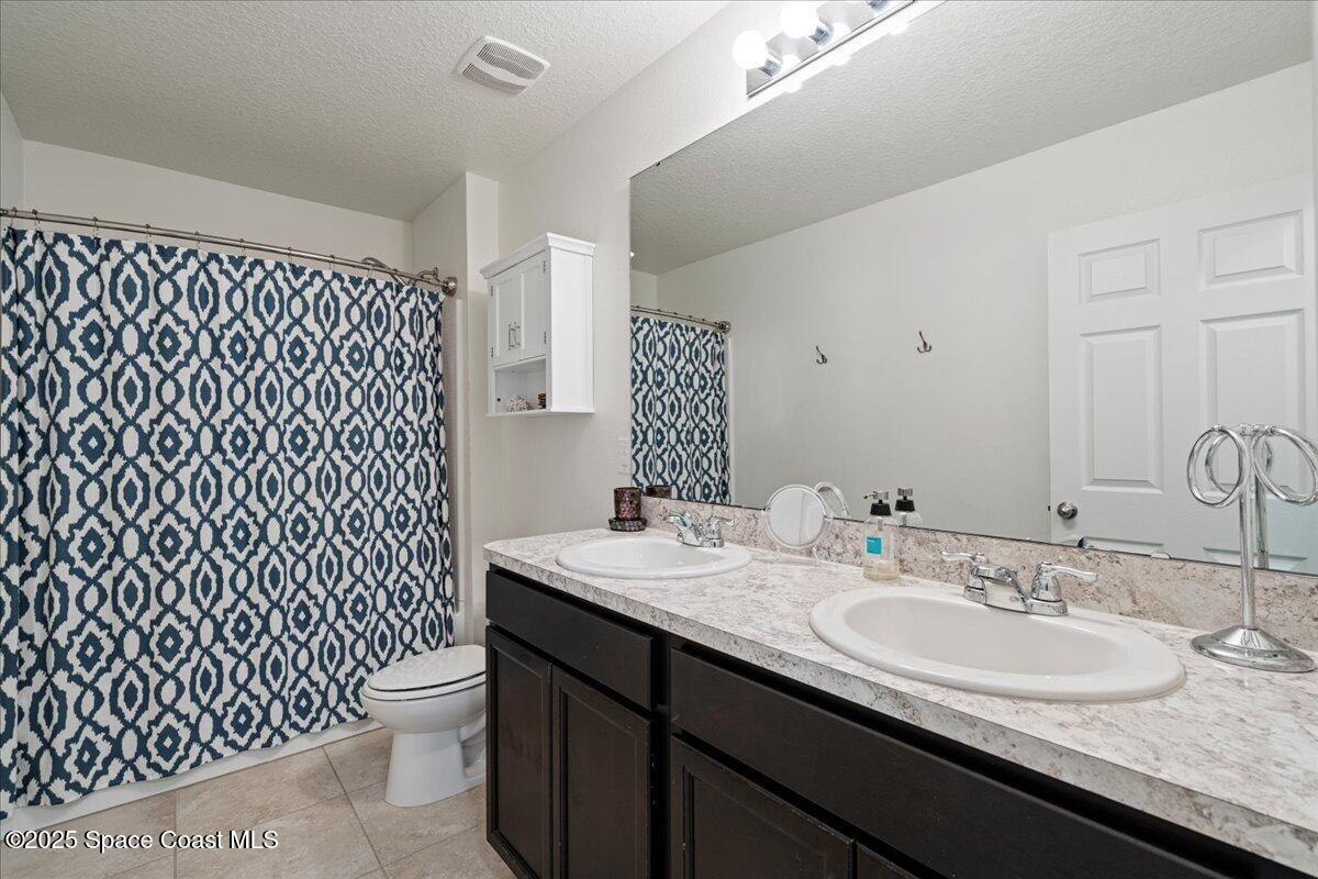 1120 Swiss Pointe Lane Rockledge, FL 32955 - Photo 28 of 47 a bathroom with a granite countertop sink and a mirror