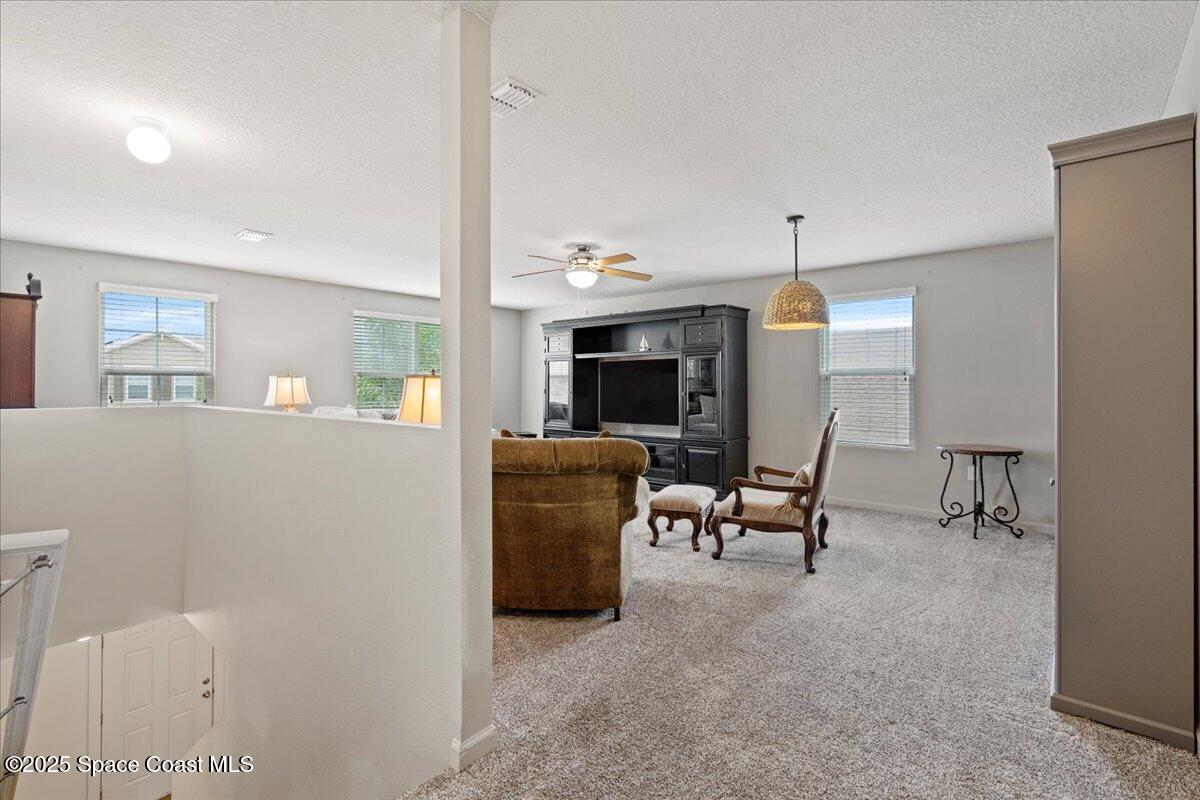 1120 Swiss Pointe Lane Rockledge, FL 32955 - Photo 31 of 47 a living room with furniture and a fireplace