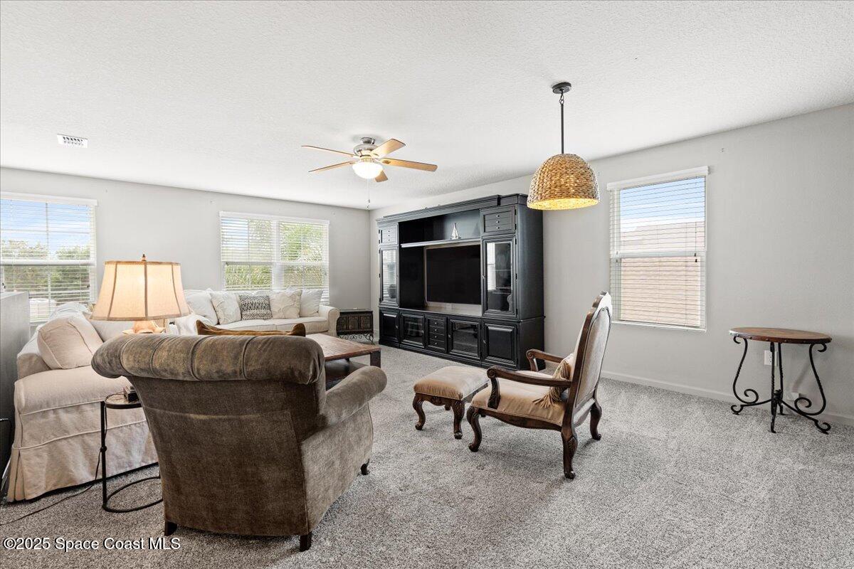 1120 Swiss Pointe Lane Rockledge, FL 32955 - Photo 32 of 47 a living room with furniture and a flat screen tv