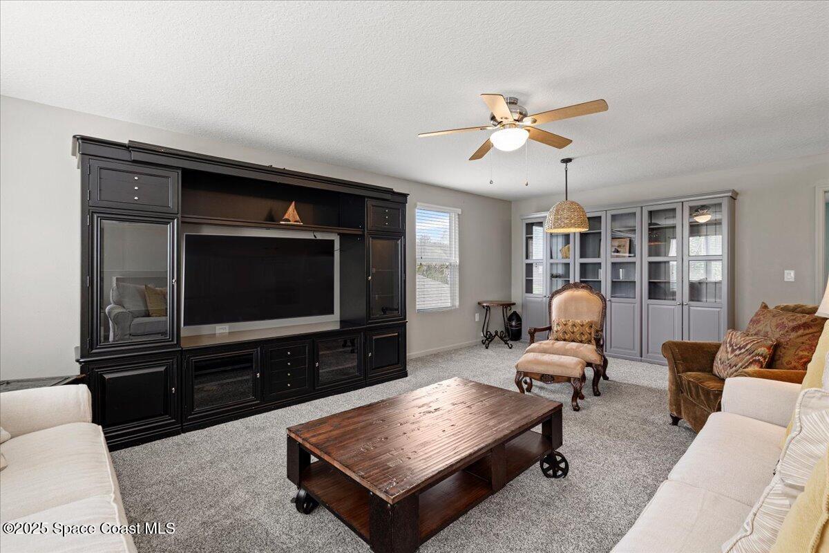 1120 Swiss Pointe Lane Rockledge, FL 32955 - Photo 35 of 47 a living room with furniture and a flat screen tv