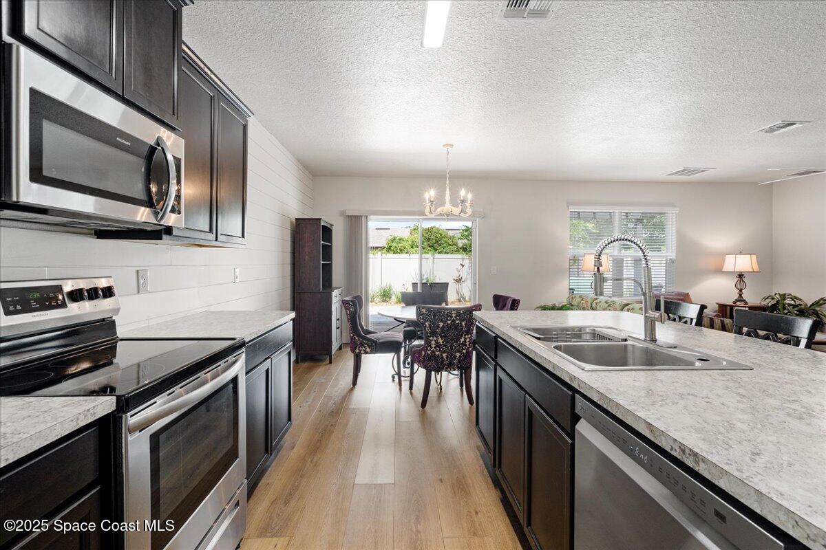 1120 Swiss Pointe Lane Rockledge, FL 32955 - Photo 7 of 47 a kitchen with lots of counter top space a sink and appliances