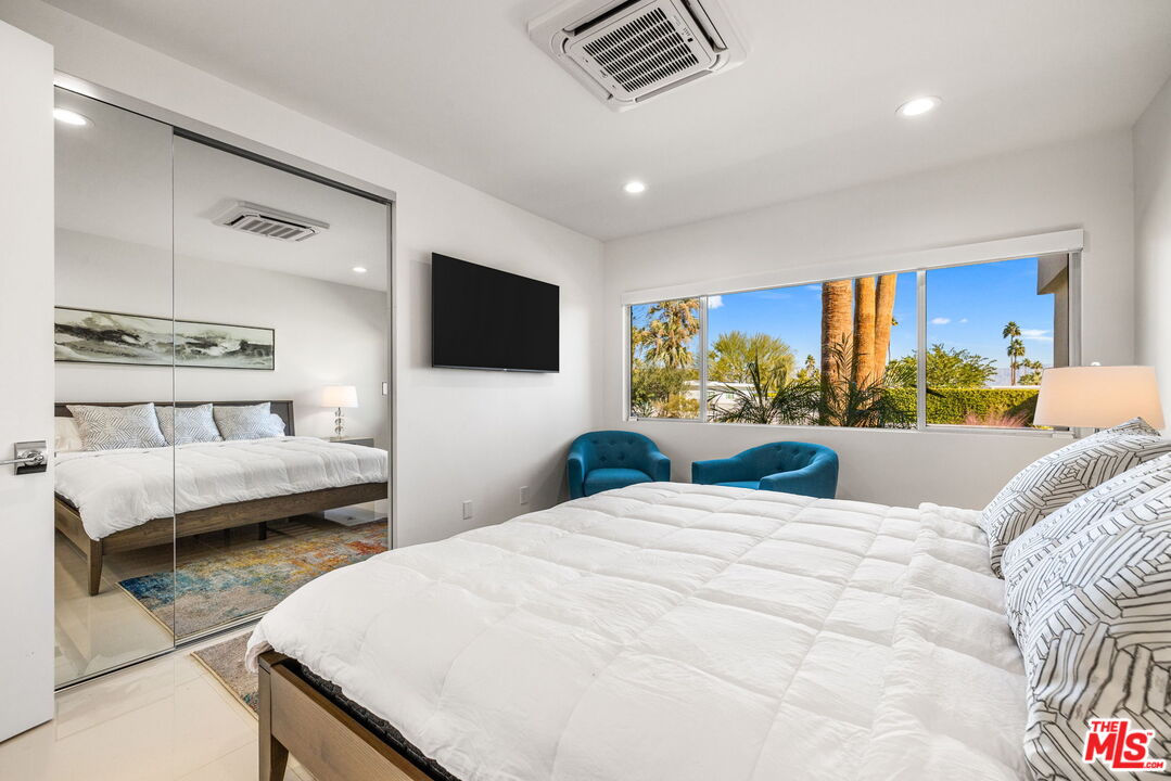 71581 Halgar Road Rancho Mirage, CA 92270 - Photo 39 of 46 a bedroom with a bed and glass window