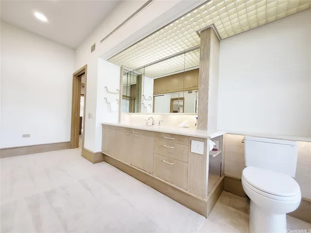 a bathroom with a sink a toilet and mirror