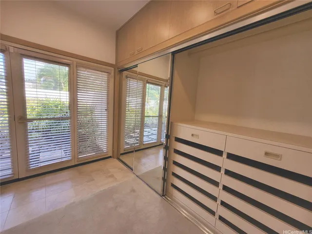 a view of a room with wooden walls and windows