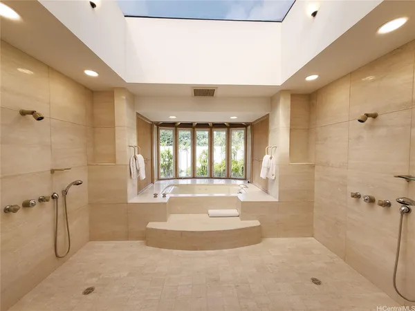 a spacious bathroom with a tub and shower
