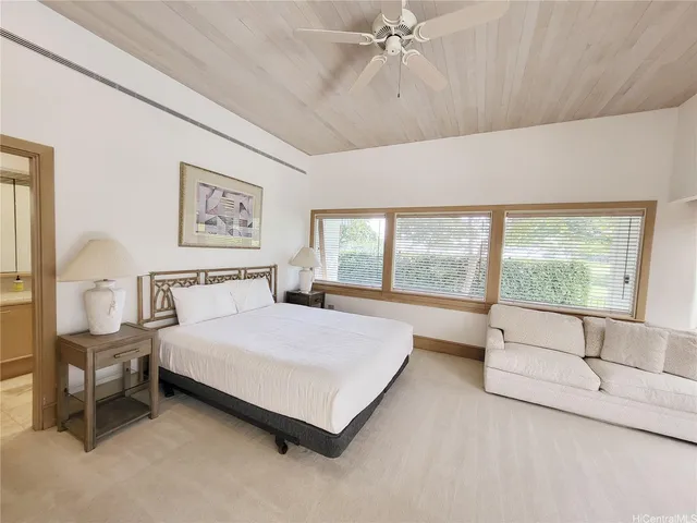 a spacious bedroom with a bed and a large window