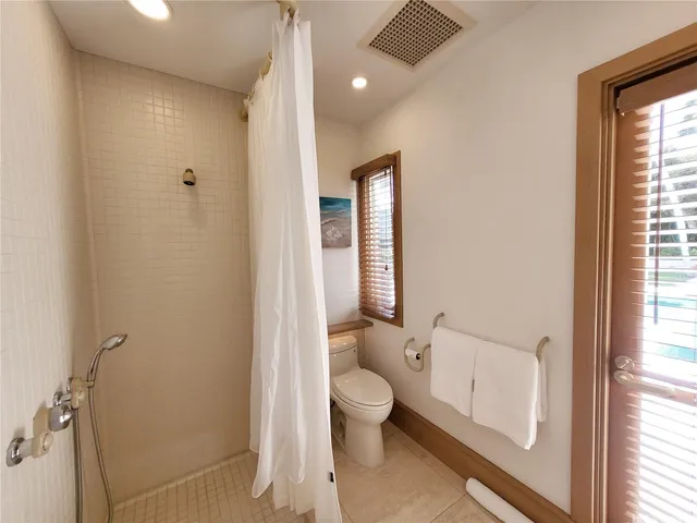 a bathroom with a toilet a sink and a window
