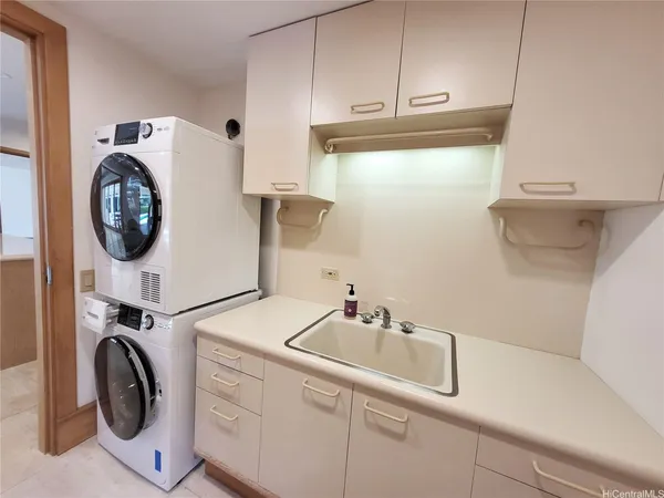 a utility room with sink dryer and washer