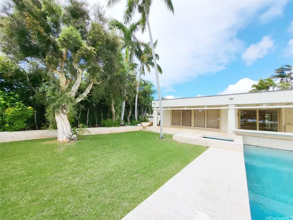 a view of a house with a yard and sitting area