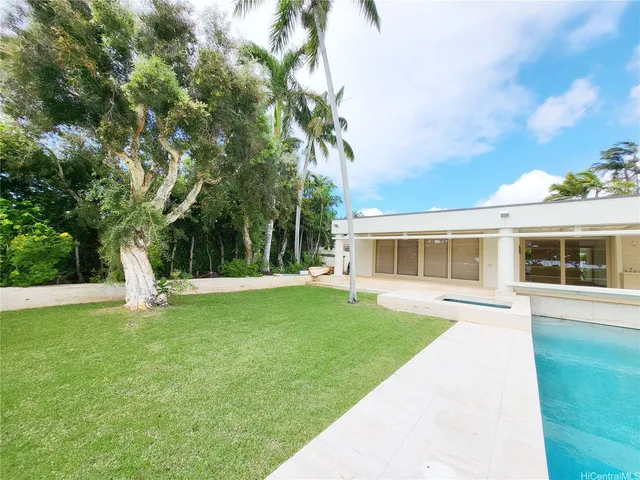 a view of a house with a yard and sitting area