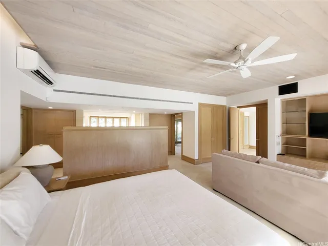 a bedroom with a large bed and a chandelier