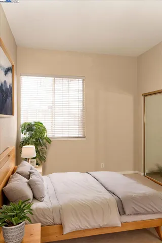 a bedroom with a bed and window
