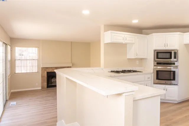 a kitchen with a stove a sink and a refrigerator