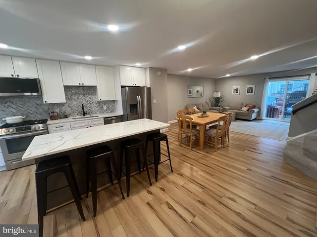 a large kitchen with a table and chairs